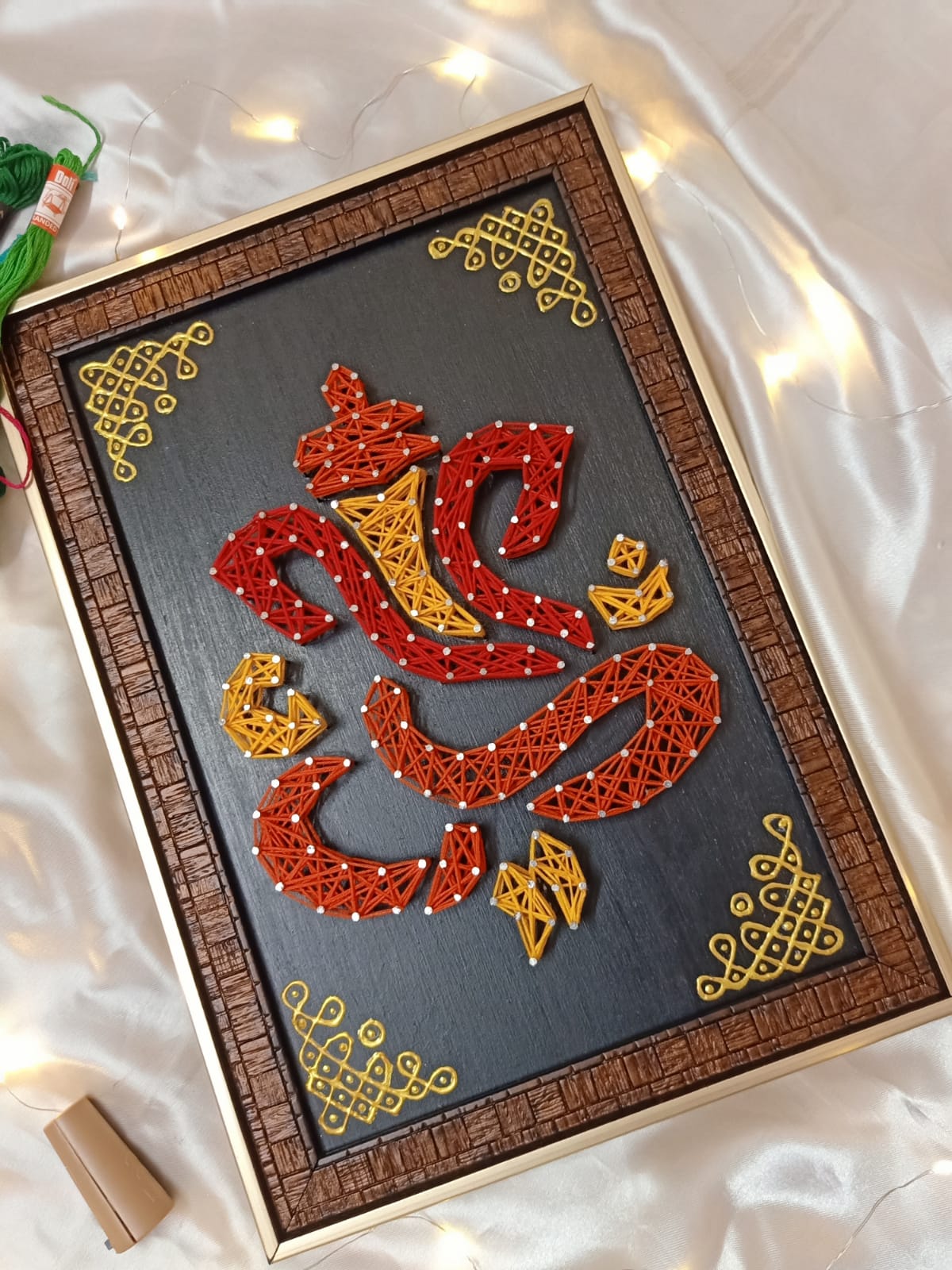 Original Vinayaka-inspired sacred motif thread art with red and gold threads